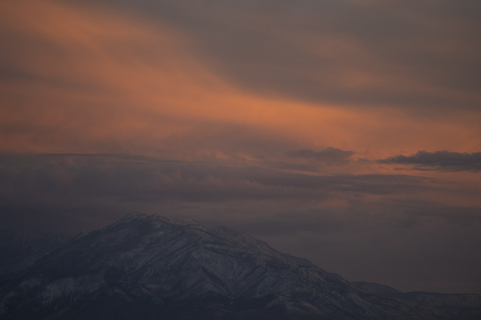 Mount Nebo in blue with a wavy salmon sunset cloud above